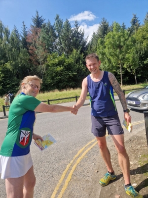 Leg 12 runner Steve White (PFO) hands over to Liz Hamer-Davies on Leg 1 at Heaton Park