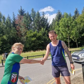 Leg 12 runner Steve White (PFO) hands over to Liz Hamer-Davies on Leg 1 at Heaton Park, Source:Marie Roberts